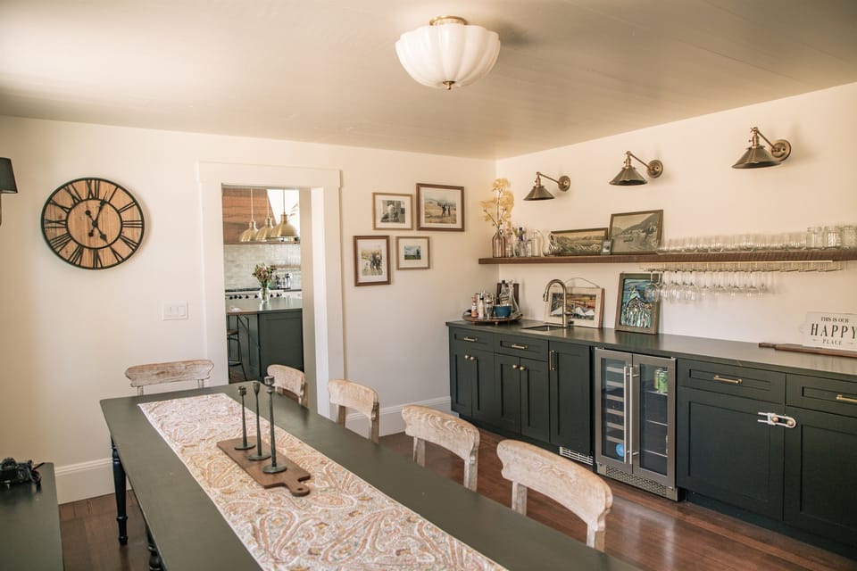 Large dining room with antique dining table (original to the house!), beverage refrigerator, wet bar with nugget ice maker and sink. Plenty of seating for a group meal. 