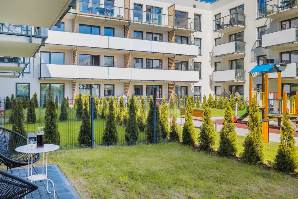 A view of the courtyard featuring a playground, green spaces, and a family-friendly atmosphere.
