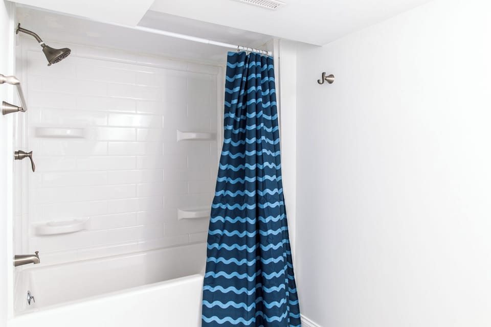 Full bathroom with bathtub in the basement