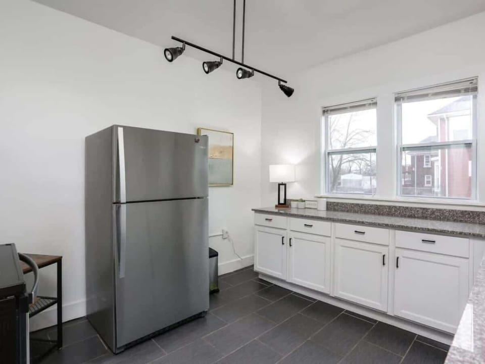 Bright kitchen with granite counters and window views