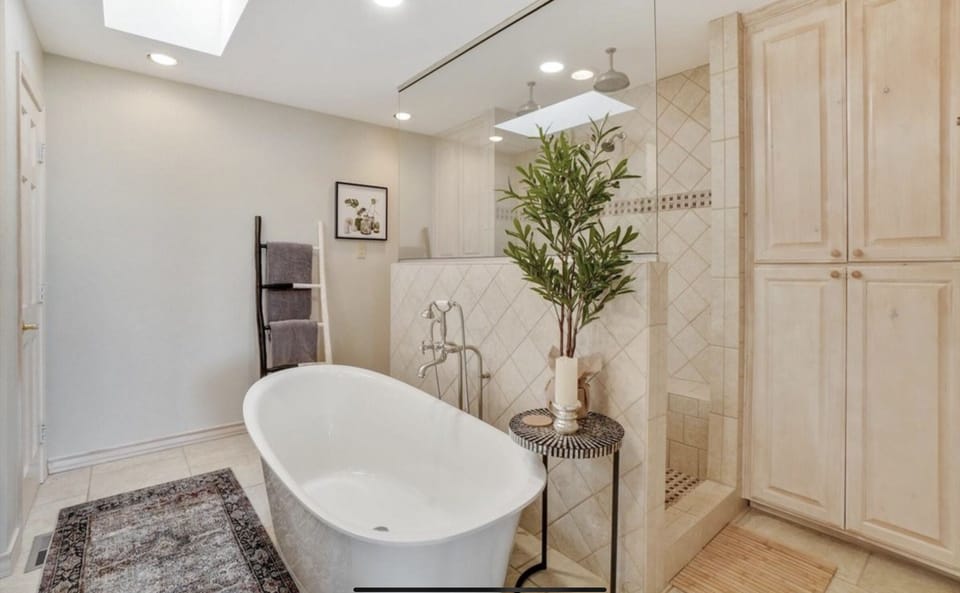 Bathroom off primary bedroom, triple-headed shower, soaking tub, dual sinks