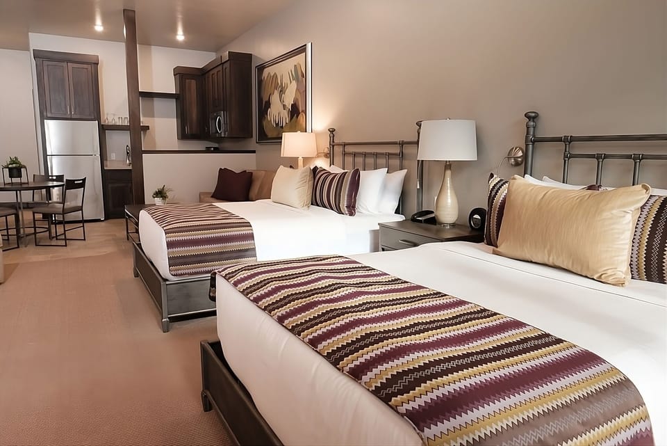 Unwind in crisp beds with a bright, modern studio vibe.