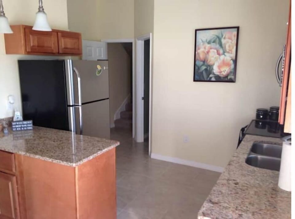 Kitchen with refrigerator, stove and microwave.