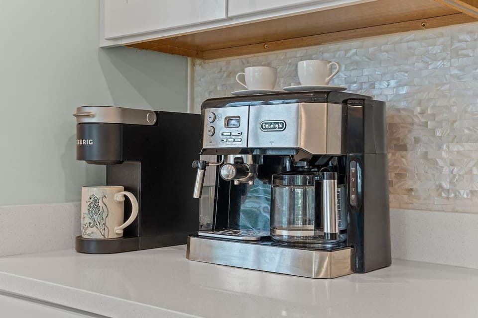 Our coffee bar is thoughtfully equipped with a Keurig coffee maker, De'Longhi espresso machine, French press, and coffee grinder, along with a starter kit to get you brewing. Begin your day savoring your favorite cup of coffee.