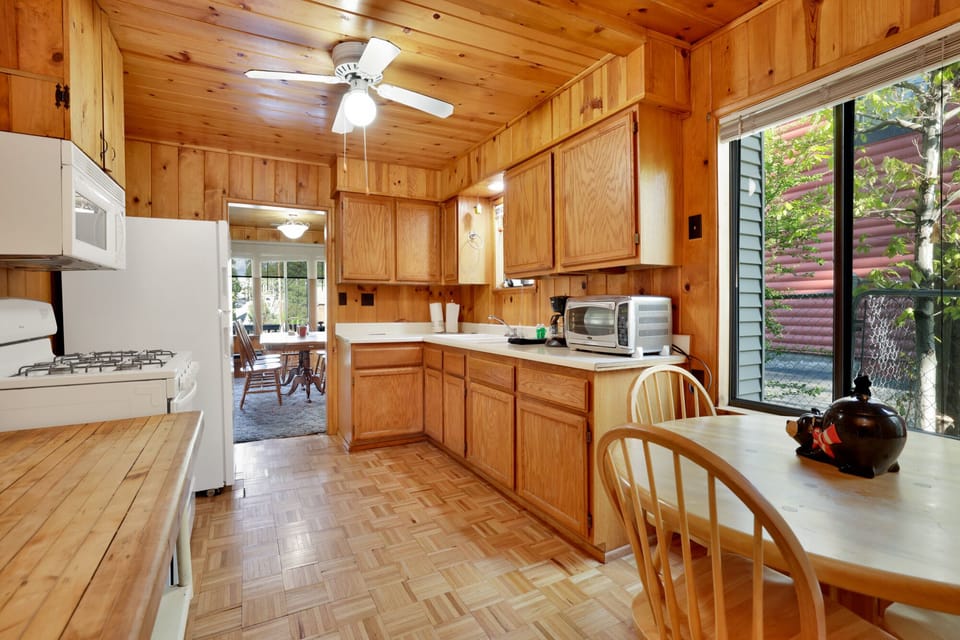 Fully equipped cabin kitchen with ample cabinetry, stove, fridge, microwave, and coffee maker—perfect for cooking meals, morning coffee, and feeling right at home on your stay.