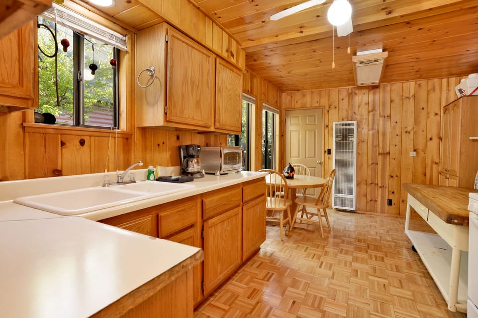 Fully equipped cabin kitchen with ample cabinetry, stove, fridge, microwave, and coffee maker—perfect for cooking meals, morning coffee, and feeling right at home on your stay.