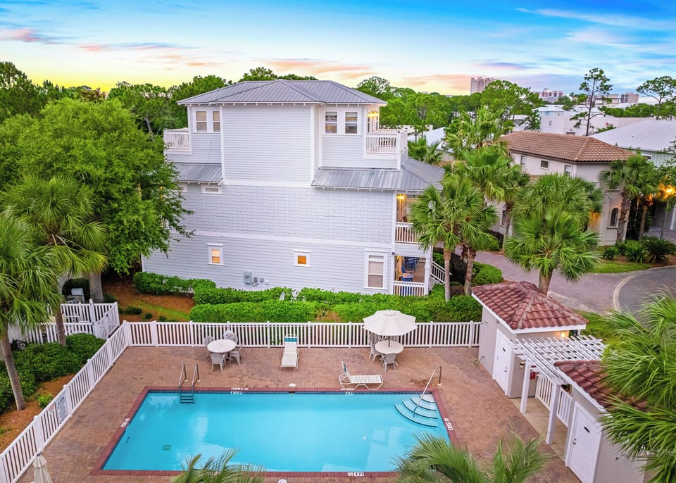 With the community pool right next door, watching the family play right from  your porch makes for an  easy breezy day.