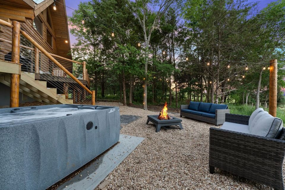 Another view of the back patio with seating around the fireplace.
