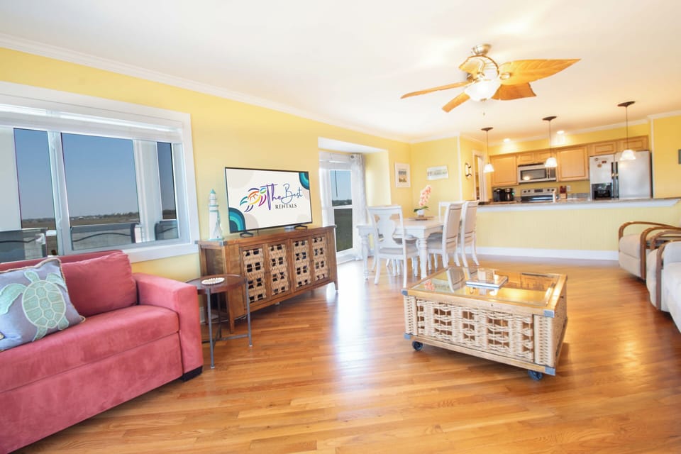 You'll love this bright, open-concept space where sunny yellow walls meet polished hardwood floors. Relax in the cozy living area, whip up meals in your fully equipped kitchen, and enjoy waterfront views right from your windows.