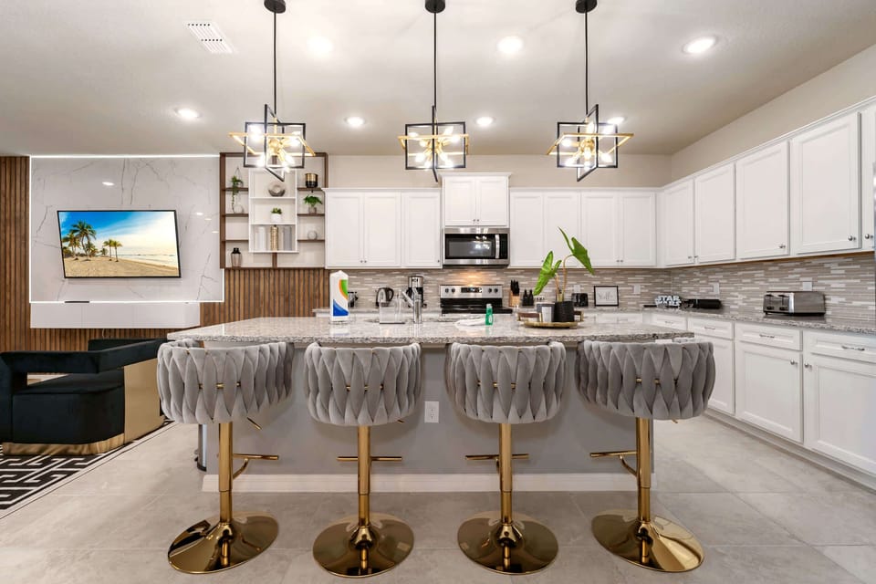 Sleek and stylish kitchen with modern amenities and a cozy seating area, perfect for entertaining.