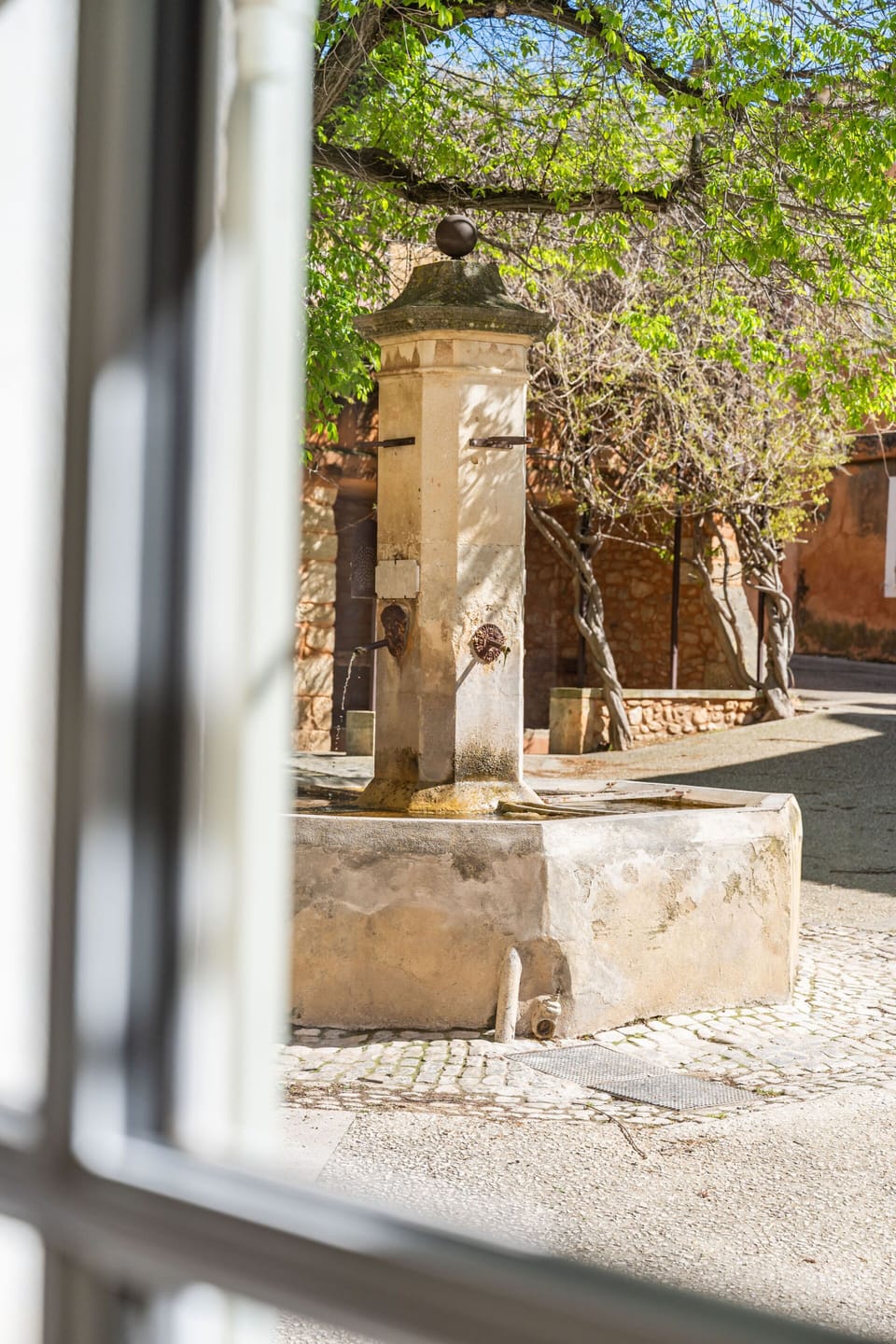 View from the lounge over the little square and the fountain