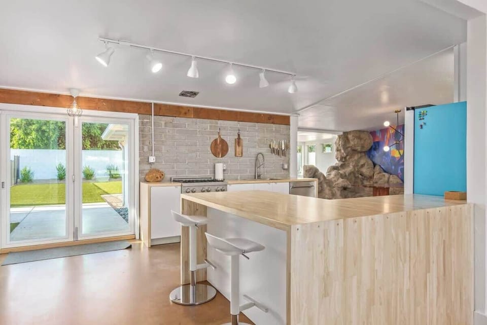 Open kitchen with exposed brick and island seating
