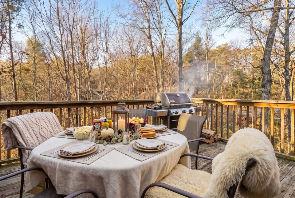 The back deck has a gas grill and outdoor dining table. Fire it up on a crisp afternoon for a cabin cookout among the trees.