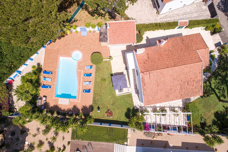 Aerial view of swimming pool and terrace with sun loungers — Villa Cassandra, luxury holiday villa in Sintra