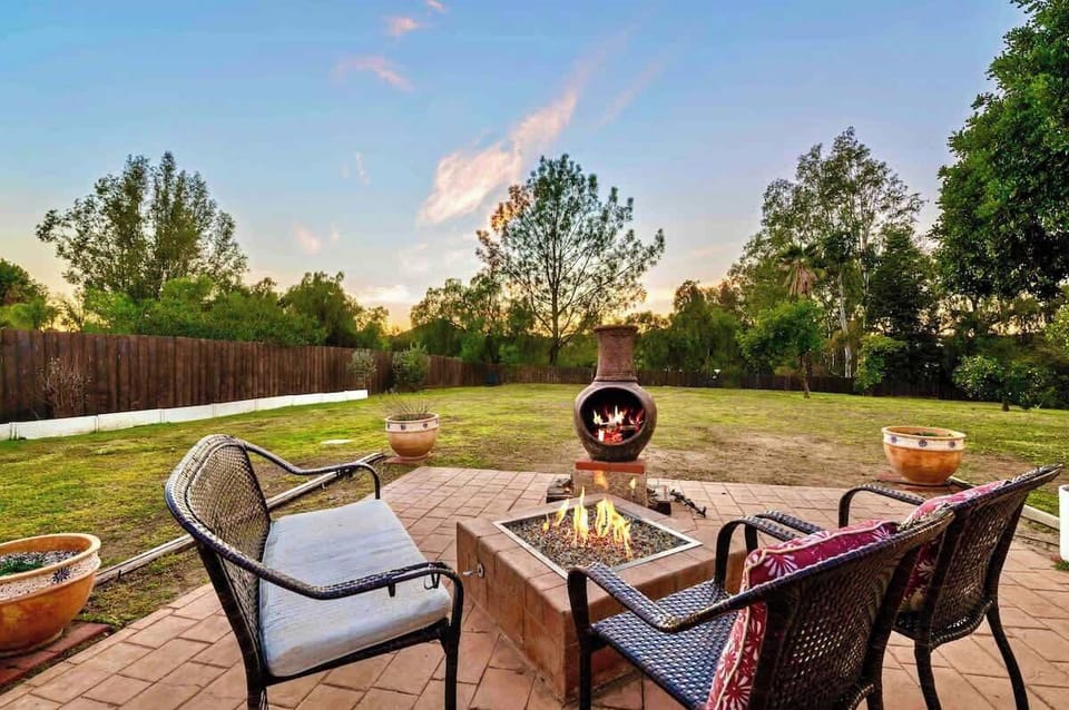 Cozy evenings await by the fire pit—surrounded by lush greenery, soft skies, and comfortable seating. The perfect setting for heartwarming conversations and marshmallow toasting under the fading daylight.