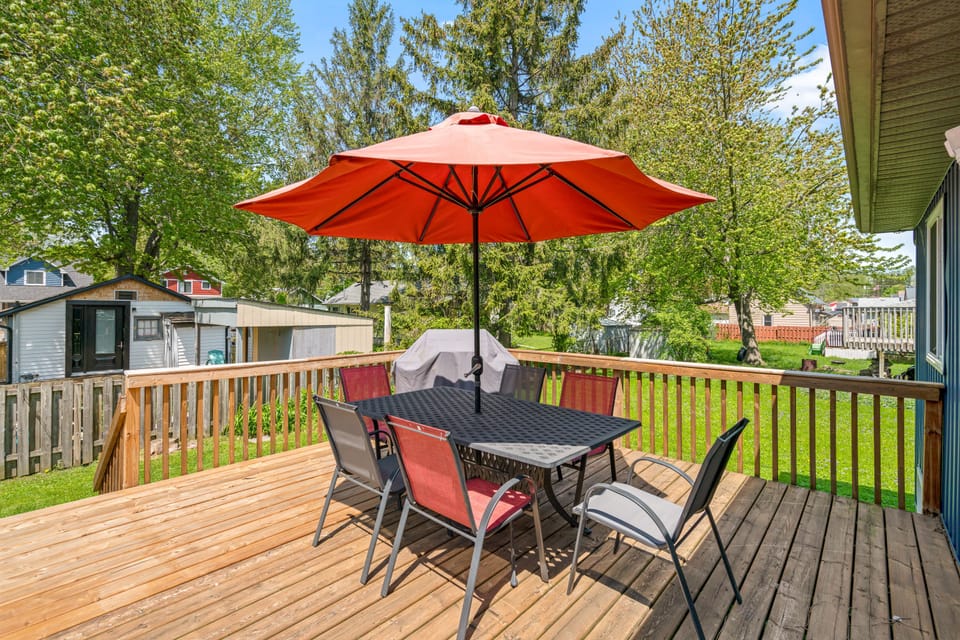 Large west facing deck on the back of the house with outdoor dining area