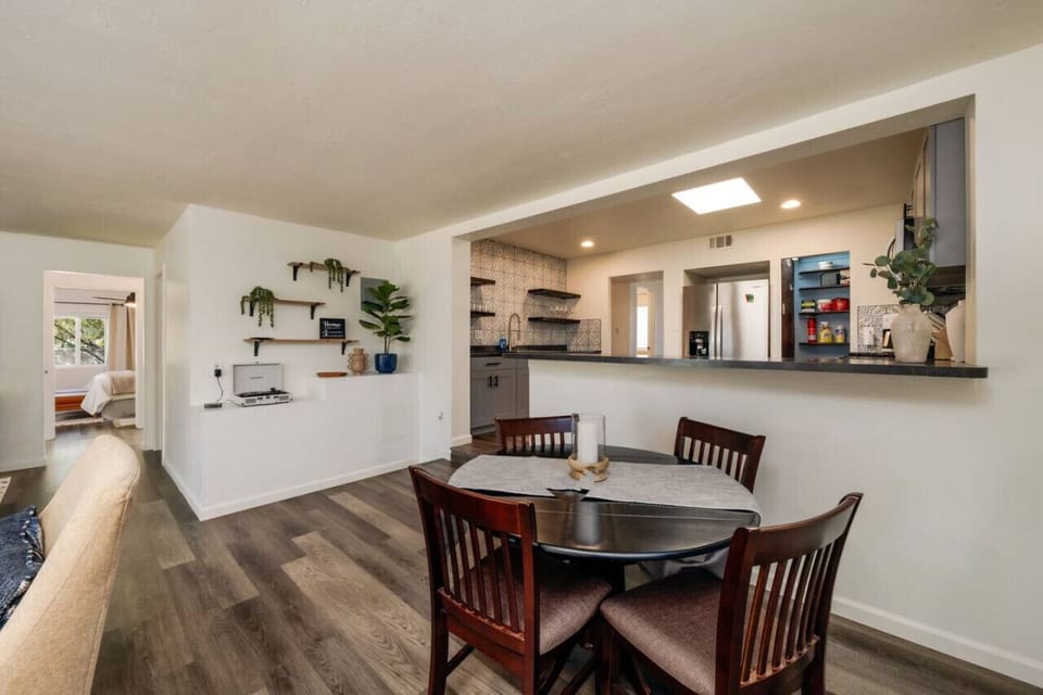 Dining area with seating for 4 and view into kitchen