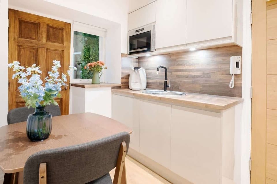 Full Kitchen | A fully equipped kitchen designed for your convenience, featuring everything you need, including a filtered fresh water dispenser (with hot and cold options), an espresso coffee machine, a dishwasher, and a washing machine/dryer