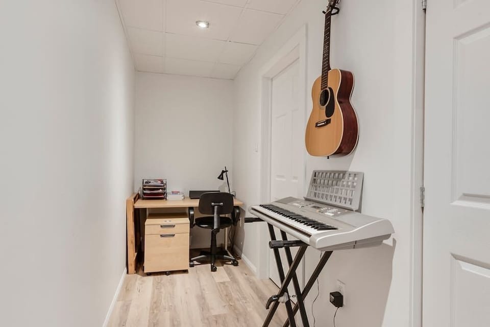 Music room with desk and piano