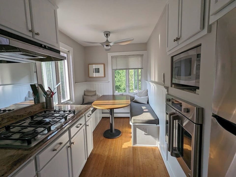 Fully equipped galley kitchen with intimate eating area.