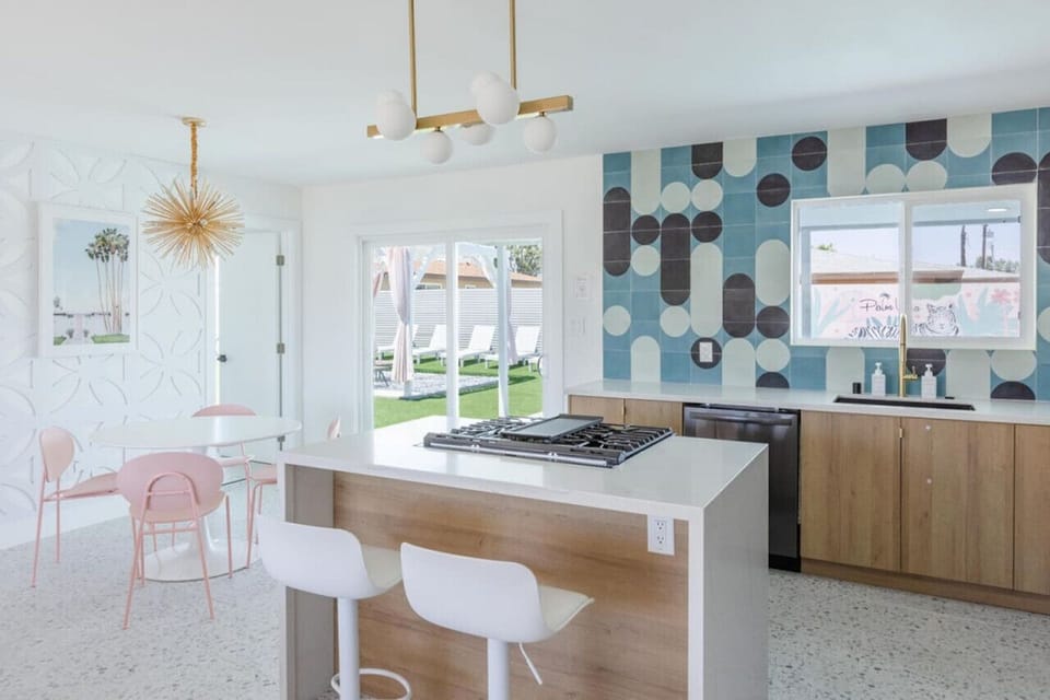 Open kitchen w/ island seating, modern finishes & plenty of light for easy meals.