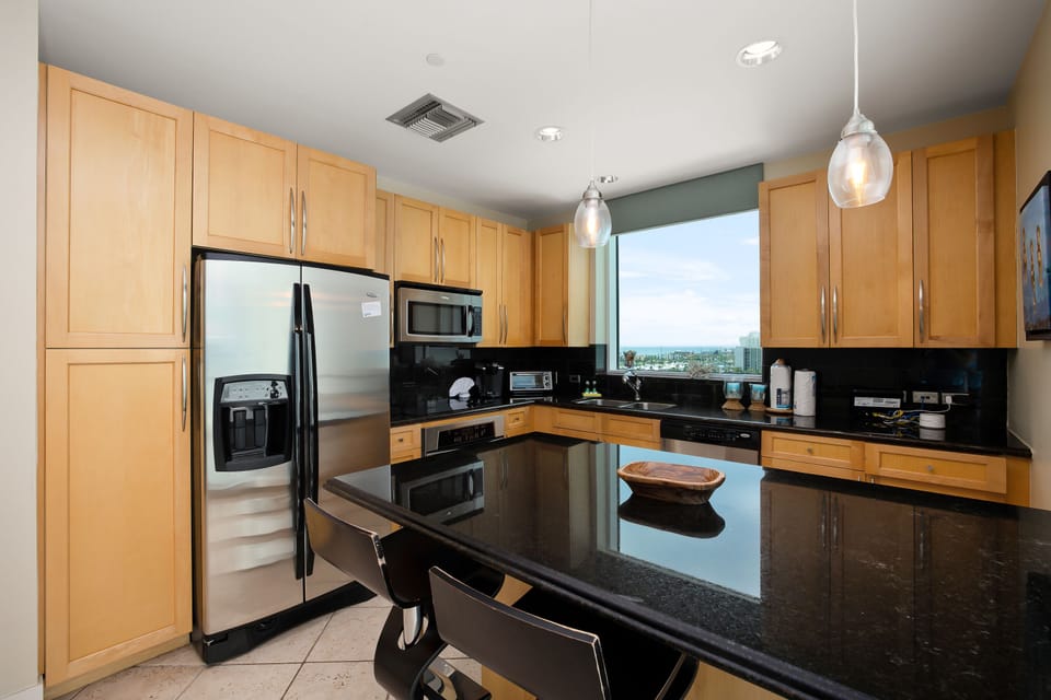 Enjoy cooking in this fully equipped kitchen, where ocean views and sleek finishes make every meal feel special.