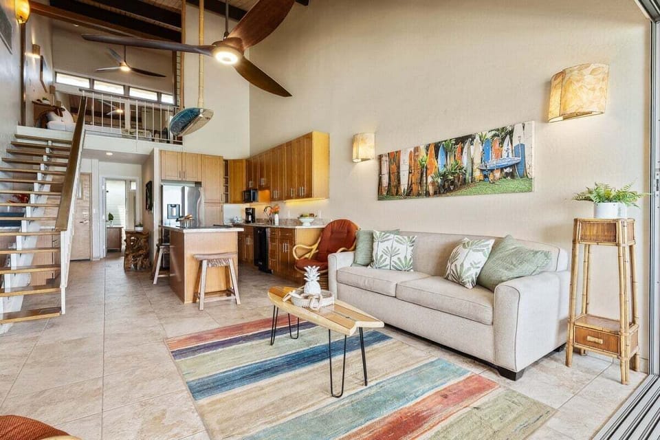 Spacious living room with sleeper sofa, TV, and coastal-inspired design.