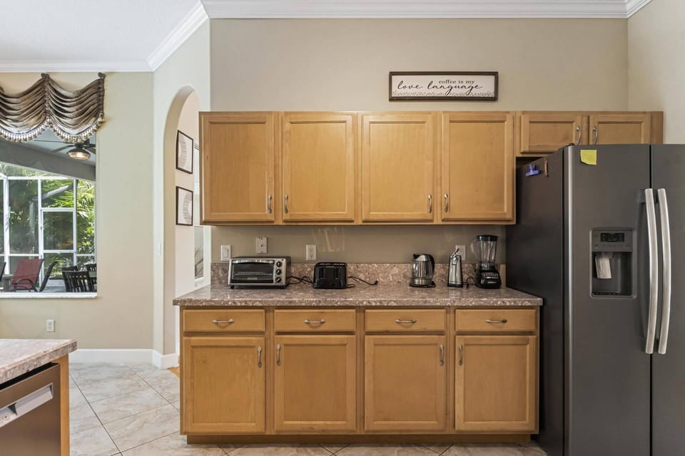The kitchen is not only spacious but also equipped with additional countertop appliances that enhance convenience and functionality.