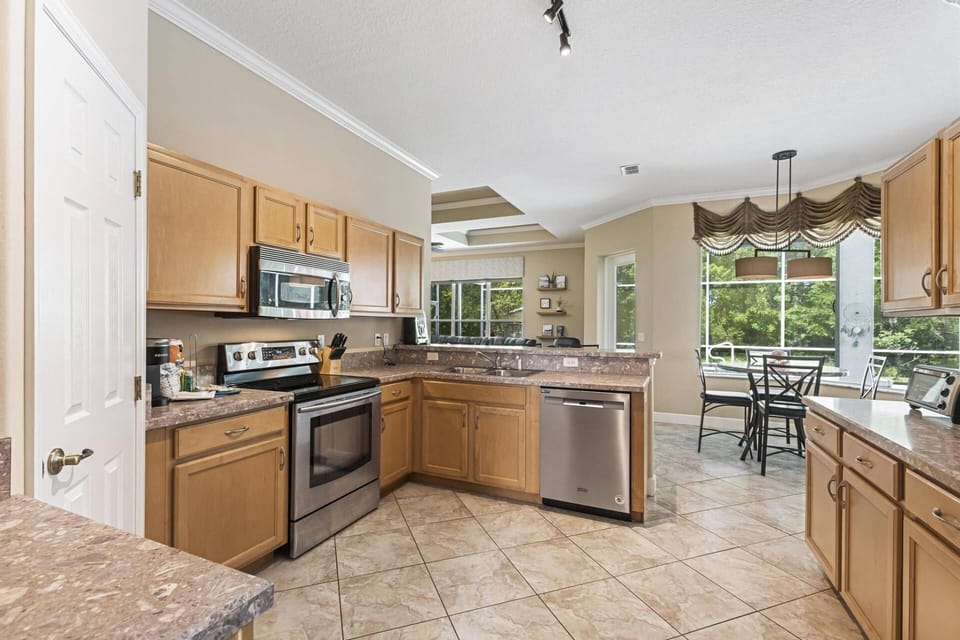 The kitchen area is a culinary haven, boasting ample counter space for easy meal preparation. Equipped with modern amenities.