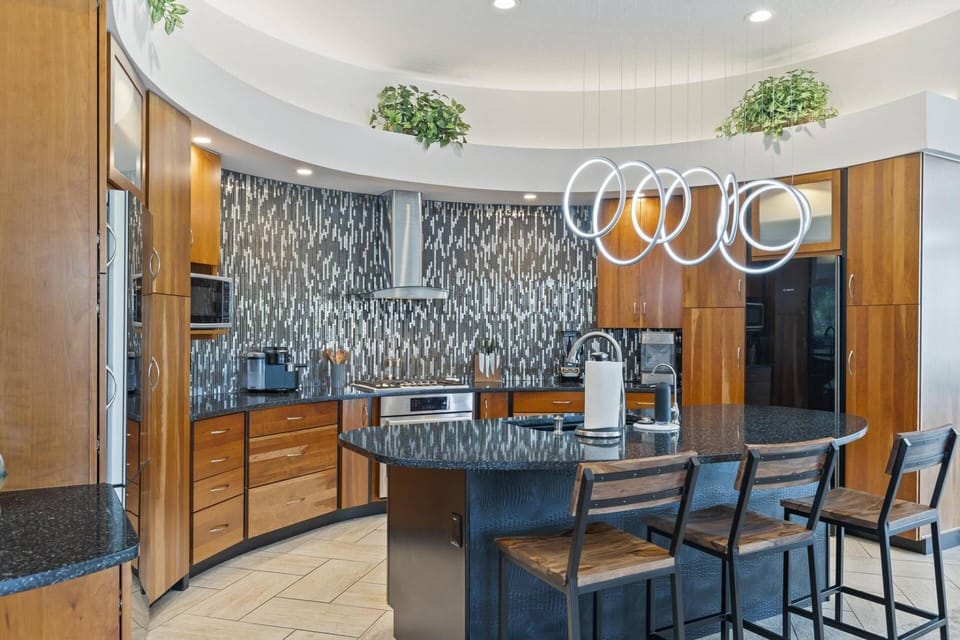 Luxury Defined: Exquisite Kitchen with Countertop Seating, Open Concept Design, and Premium Finishes