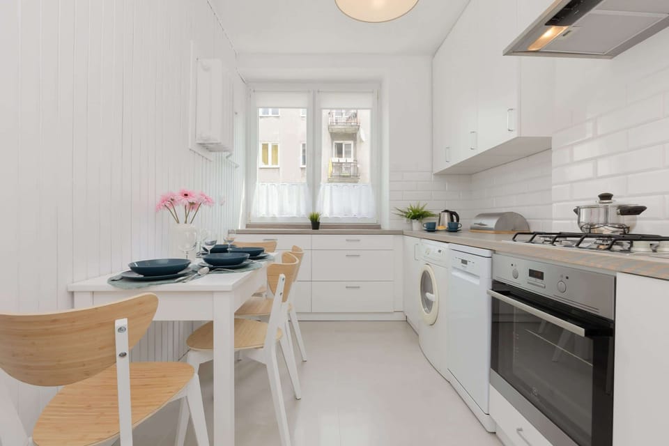 The kitchen's sleek design includes all necessary cookware and utensils. 