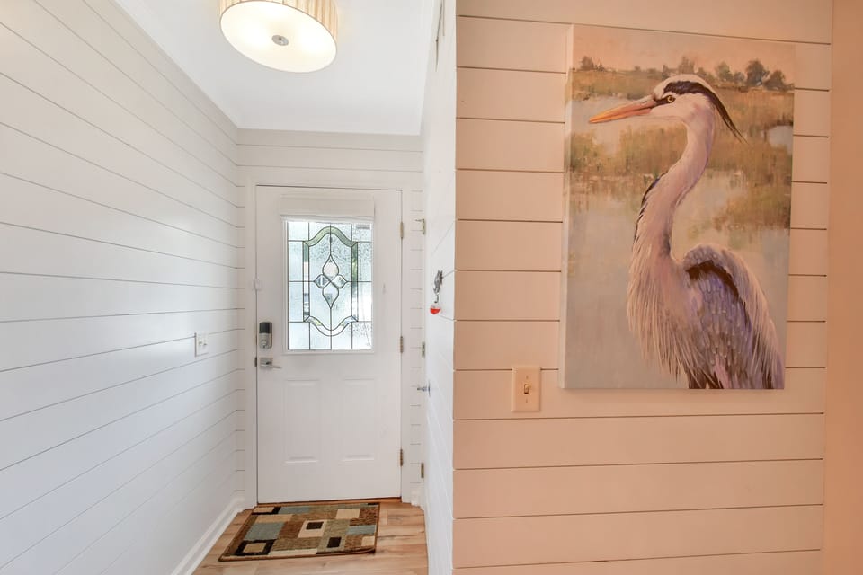Bright Coastal Entry with Shiplap Walls - Step into Courtyard Villas E-5 and you’re greeted by classic shiplap, soft lighting, and subtle coastal décor. This charming St. Simons vacation rental sets the tone for a relaxing, dog friendly island stay from the moment you walk in.