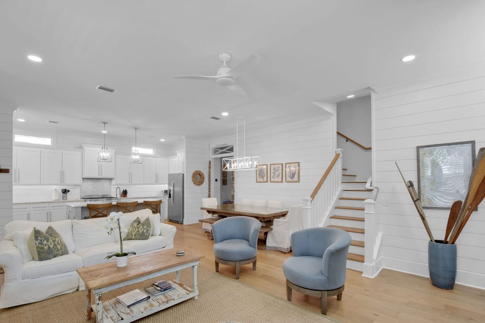 Main Living Space with Kitchen & Dining – Open Staircase Layout - The main floor connects everything—kitchen, dining, living, and a clean line to the upstairs bedrooms. It’s open, airy, and laid out for real-life together time.