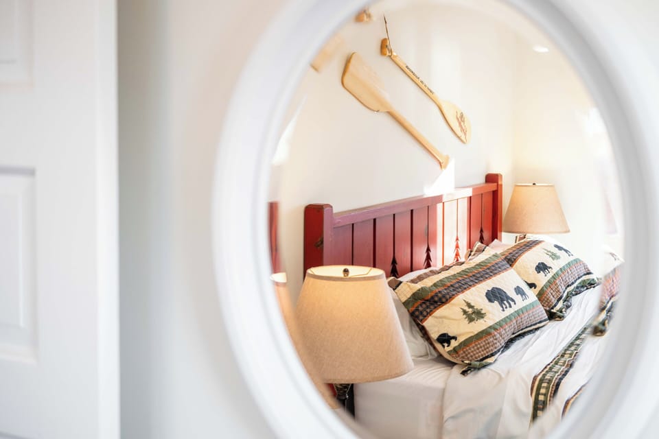 Slip into your cozy bedroom with charming nautical touches, complete with bedside lamps for evening reading.