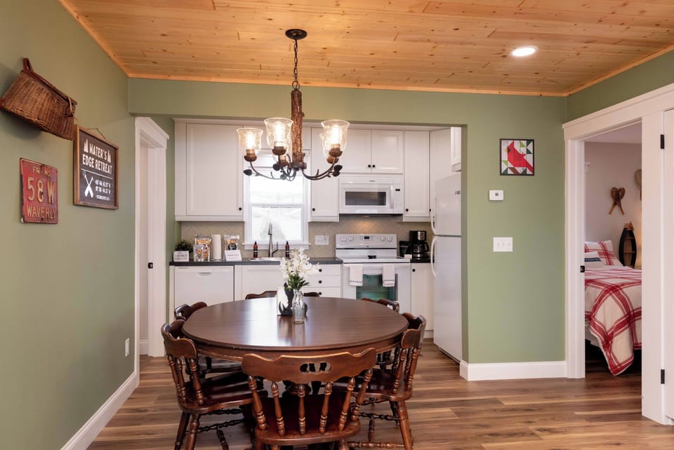 Gather around this rustic dining table where your family meals become treasured memories under warm chandelier light.