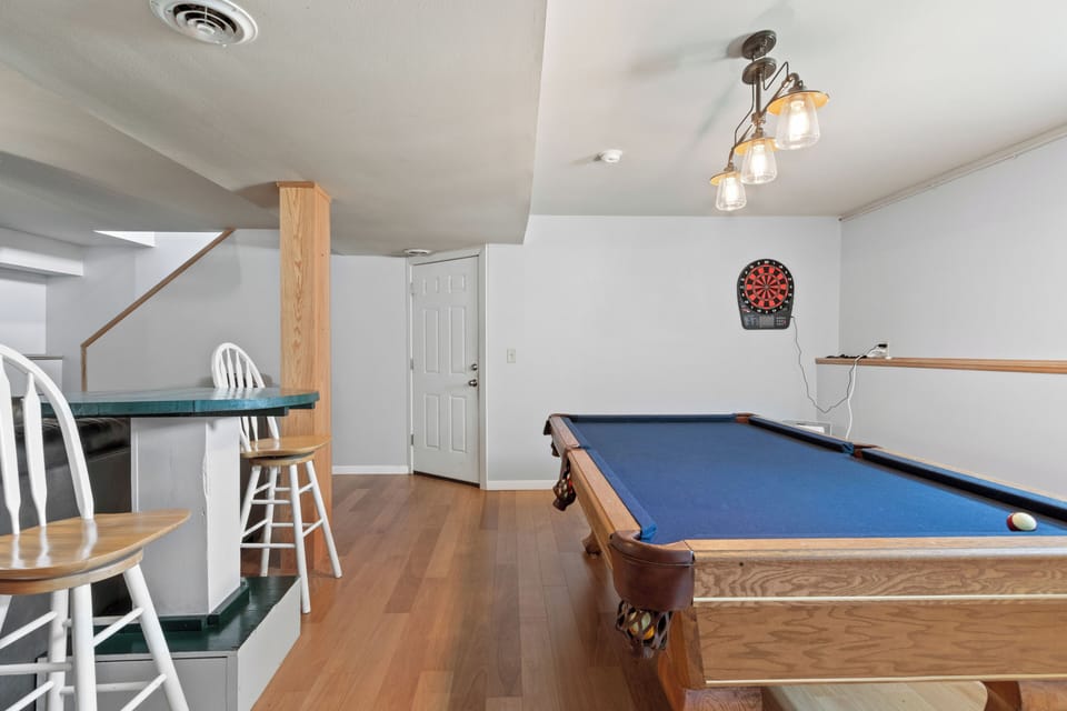 Game Area with Pool Table, Dart Board, and Pub Style Table