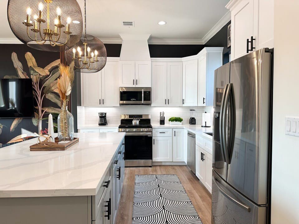 FULLY STOCKED large kitchen and Island is accented by gorgeous encaged candelabra pendant lights. This is the perfect kitchen to host large dinner parties and/or feasts for all your guests. 