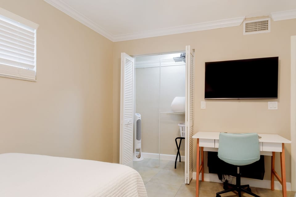 Second bedroom also features spacious closet, work space, Smart TV, floor fan and luggage rack.