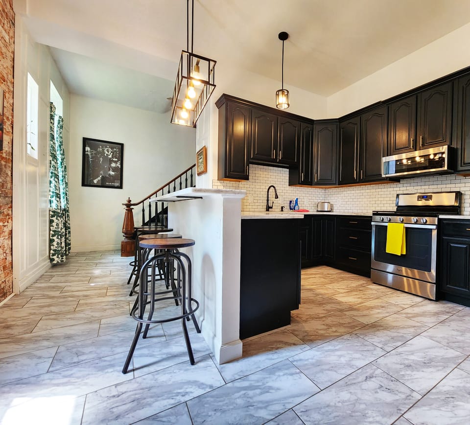 Updated and well-stocked kitchen with an oversized sink and dishwasher.