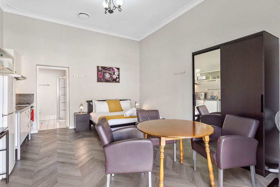 Enjoy meals and conversation at the inviting dining table, surrounded by natural light and a warm ambiance.