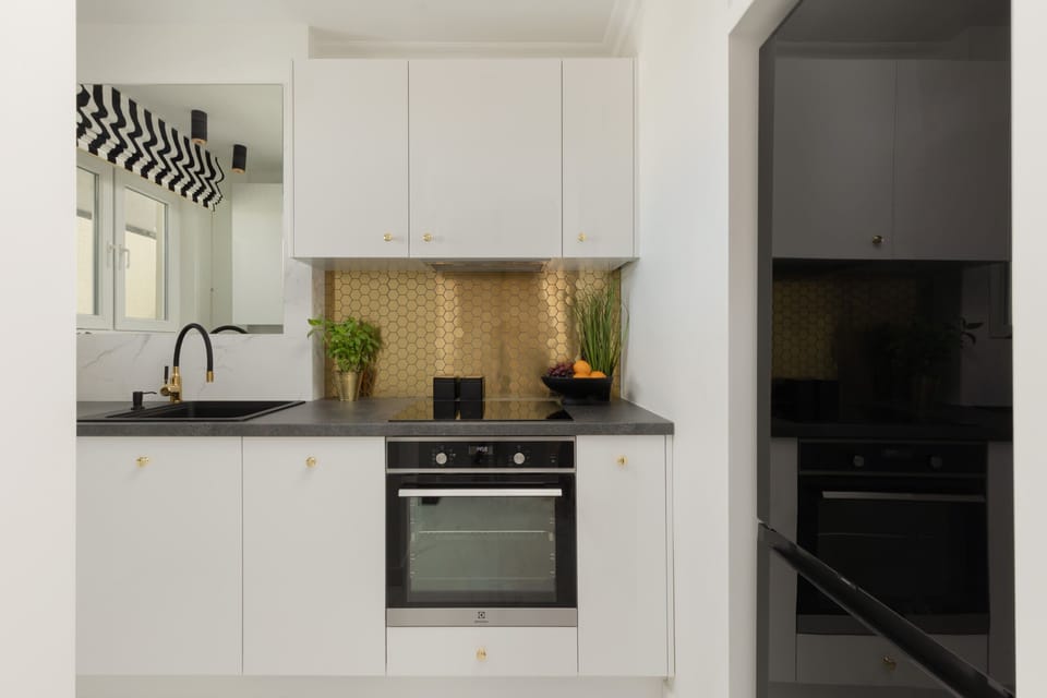 The sleek design of the kitchenette blending seamlessly with the living area.