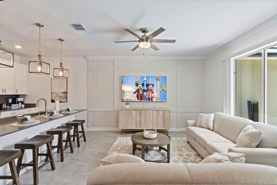 Captivating living area of the townhouse in Kissimmee Florida - Harmonious blend of textures and materials - Cozy seating area conducive to relaxation and socializing - Harmonious color scheme with pops of accent colors for visual interest