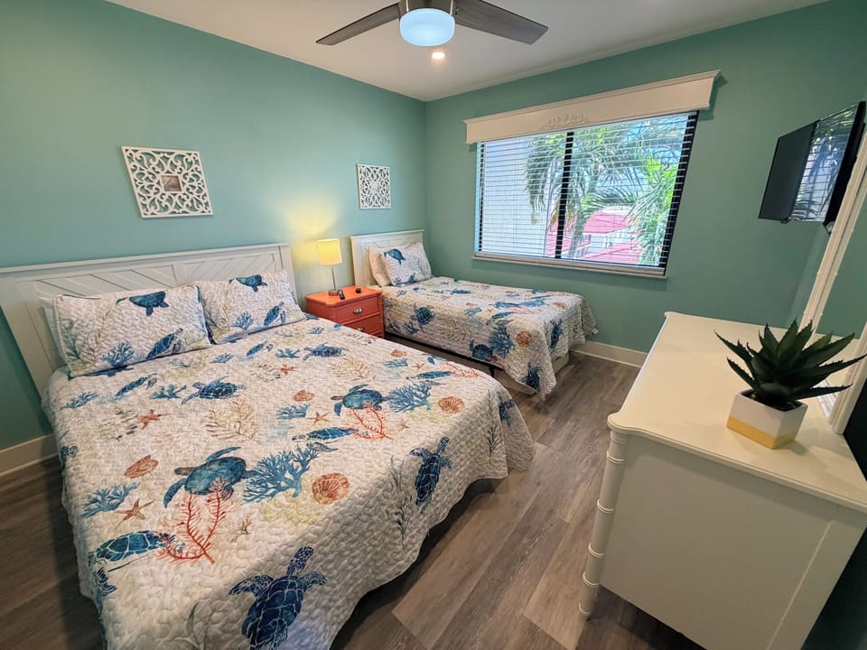 Drift off in your coastal bedroom where ocean-themed bedding and soothing sea-glass walls create the perfect tropical retreat for restful nights.