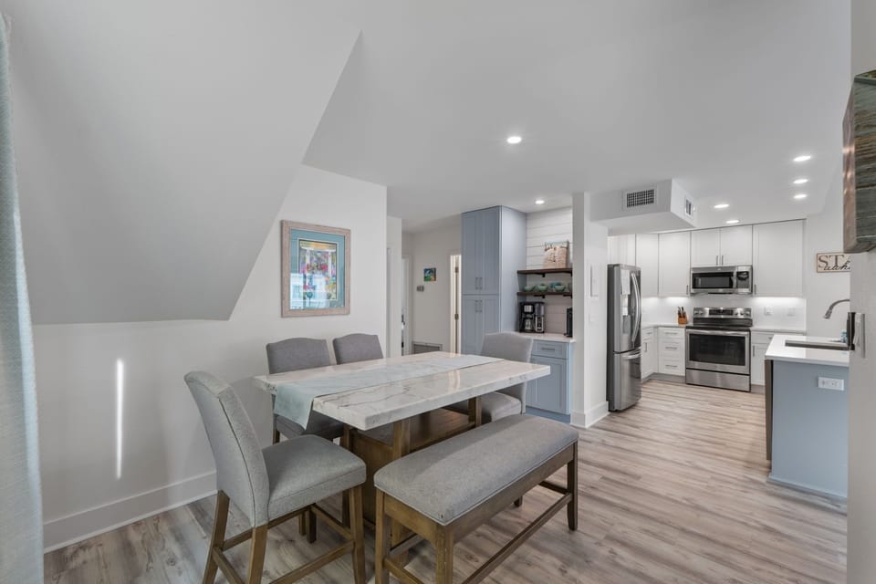 Your modern dining space flows seamlessly into a fully equipped kitchen, perfect for gathering around meals and creating memories together.