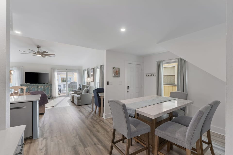 Relax in your bright, open-plan living space with modern dining and comfortable seating areas flowing seamlessly together.