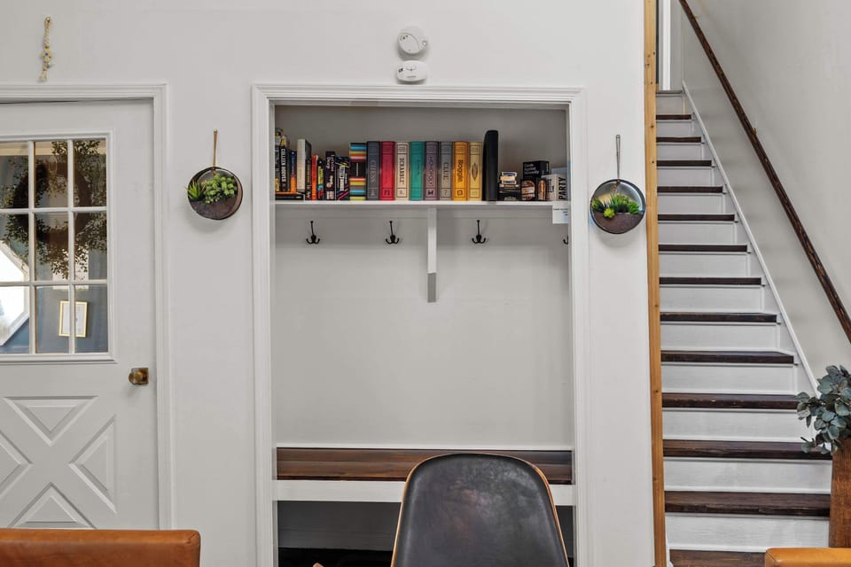 Step into a welcoming entryway with a bench to unwind, a place for shoes and coats, and slippers ready for you.