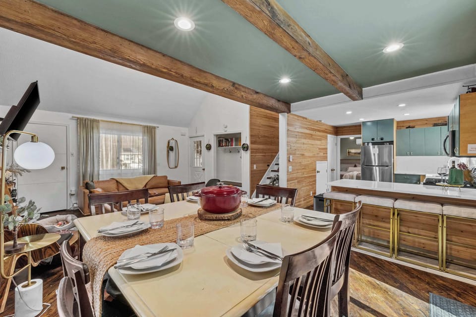 A welcoming dining space with a view of the inviting living room—perfect for shared meals, great conversations, and relaxing moments.