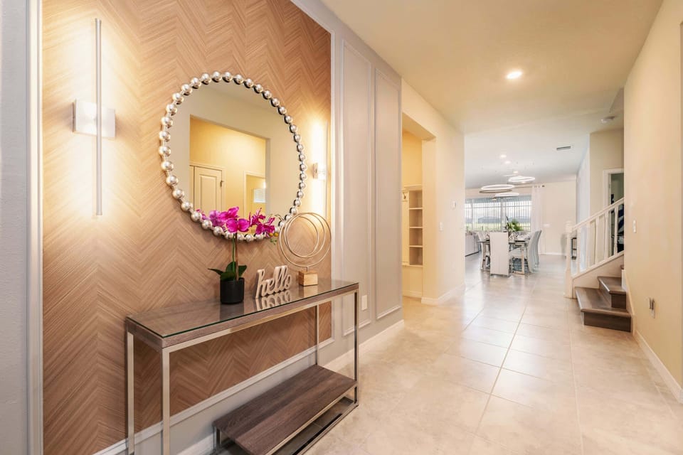 Welcome to your luxurious villa retreat, featuring a stylish entrance with chic decor and modern lighting.