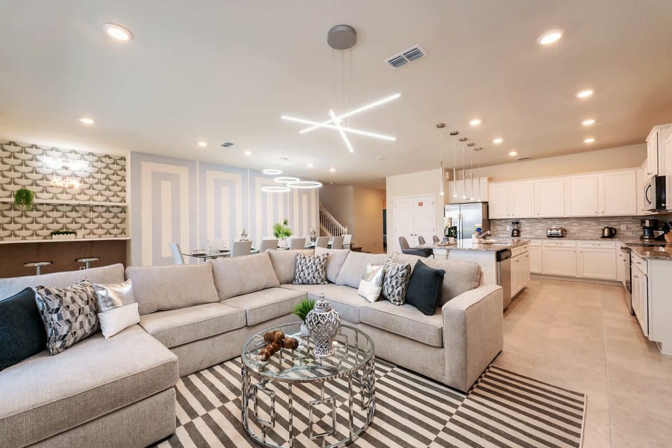 Experience luxury in this expansive open-plan living area with modern decor and ample seating, perfect for gatherings.
