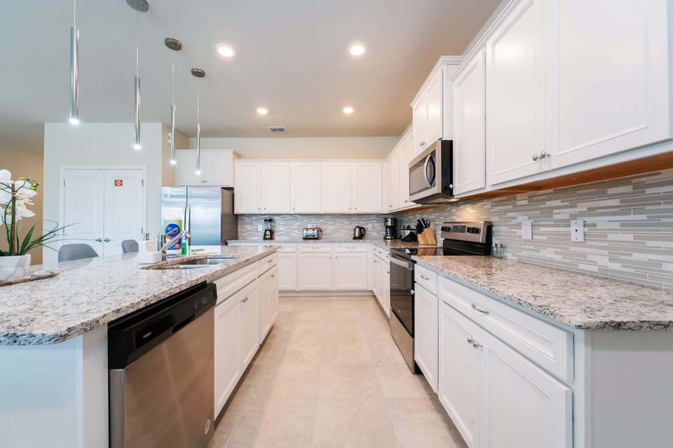 Modern kitchen with sleek appliances and ample counter space, perfect for cooking and entertaining in style.